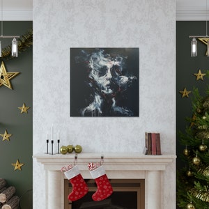 May include: Square canvas art featuring a dark, abstract portrait. The artwork uses white, red, and blue brushstrokes against a black background. The painting is displayed above a fireplace decorated with Christmas stockings and ornaments.