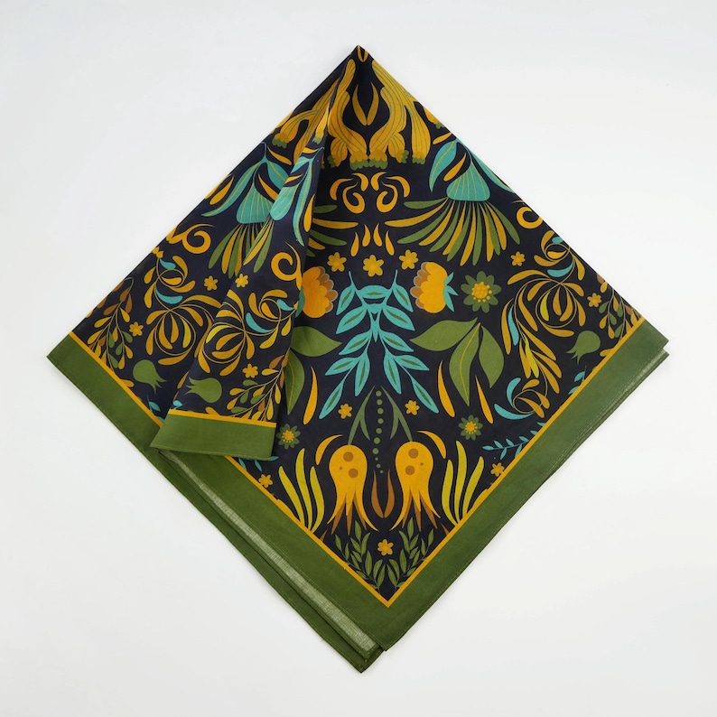 May include: A green and black bandana with a floral pattern in yellow, orange, and teal. The pattern features stylized flowers, leaves, and geometric shapes.