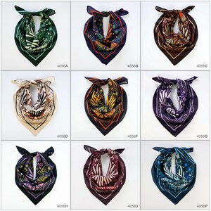 May include: Nine different patterned silk scarves in various colors, including green, orange, brown, beige, purple, and blue. Each scarf is tied in a triangular shape.