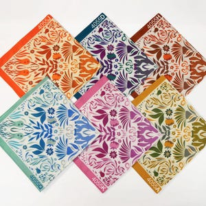 May include: Six colorful fabric squares with a floral pattern. Each square has a different color and pattern, and each square has a number printed on it. The numbers are 4055J, 4055D, 4055H, 4055Q, 4055K, and 4055A.