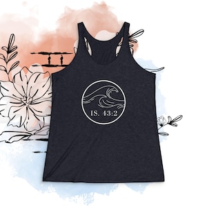 May include: Dark gray racerback tank top with a white circular graphic featuring wave illustrations and the text "IS. 43:2". The tank top is set against a watercolor-style background with floral and abstract line art.