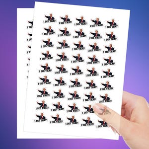 May include: Sheets of white stickers featuring a cartoon image of a man pointing with the text "I DID THAT!". The stickers are held by a hand against a purple gradient background. The stickers are small and rectangular.
