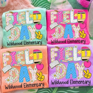 Puede incluir: Cuatro camisetas coloridas con las palabras "FIELD DAY" en un diseño floral y estampado, junto con un lápiz, una manzana, un signo de la paz y el texto "Wildwood Elementary". Las camisetas son en tonos de verde azulado, rosa, naranja y morado.