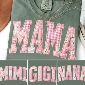 May include: Olive green t-shirt with the word "MAMA" appliqued in pink fabric with floral, gingham, and polka dot patterns. The shirt has a small Comfort Colors tag and a delicate necklace.