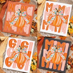 May include: Four square canvas prints featuring orange pumpkins with floral bows. Each print displays a different word in large orange and pink letters: Nana, Mama, Gigi, and Mimi. The designs include small star accents and a decorative ribbon.