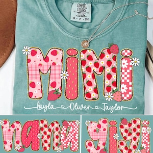 May include: A light blue t-shirt with a pink and red patchwork design that spells out "Mimi" with the names "Layla, Oliver, Taylor" written below. The shirt also features a smaller design of the same patchwork style that spells out "Nana" and "Gigi".