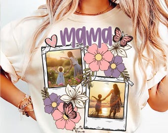 May include: A white t-shirt with the word "mama" in purple lettering and a heart design. The shirt features two photo frames with images of a mother and child, surrounded by pink and purple flowers and butterflies.