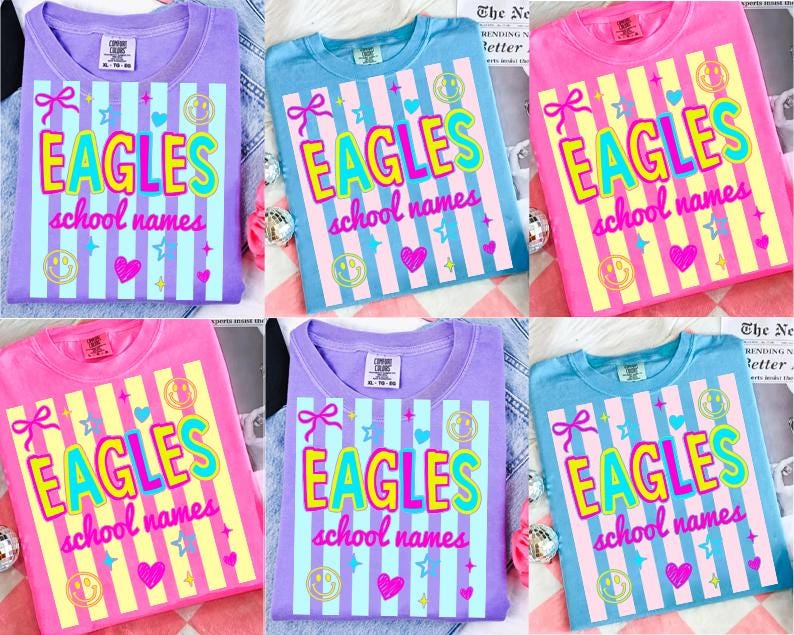 Puede incluir: Una colecci&oacute;n de seis camisetas en varios colores, incluyendo morado, azul y rosa. Cada camiseta presenta la palabra "EAGLES" en una fuente colorida y audaz, junto con "school names" y elementos decorativos como corazones y estrellas.