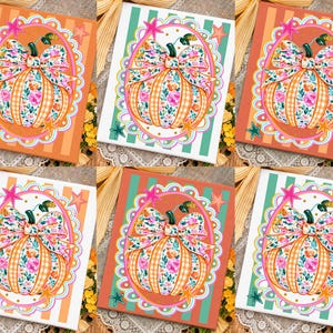 May include: A set of six square art prints featuring a central pumpkin illustration with a floral and gingham pattern, topped with a large bow. Each print is framed by a scalloped oval border with star accents, set against various striped backgrounds.