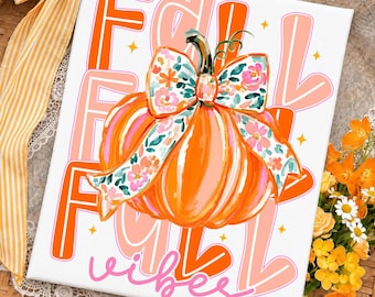 May include: A rectangular white canvas print featuring a large orange pumpkin with a floral patterned bow in shades of pink, green, and white. The background displays the text FALL in bold orange and light pink letters with small yellow stars.