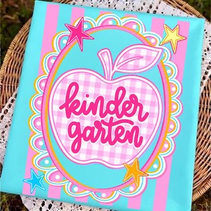 May include: A canvas with a turquoise background and pink vertical stripes. A pink and white gingham apple with the words "kindergarten" in pink script is centered. Pink, yellow, and blue stars and a scalloped border complete the design.