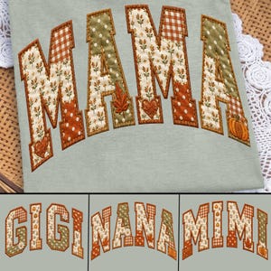 May include: A light sage green t-shirt featuring the word MAMA in large, arched, block letters. The letters are filled with a patchwork of autumn-themed fabrics, including orange gingham, white polka dots, and floral patterns with pumpkins and leaves.