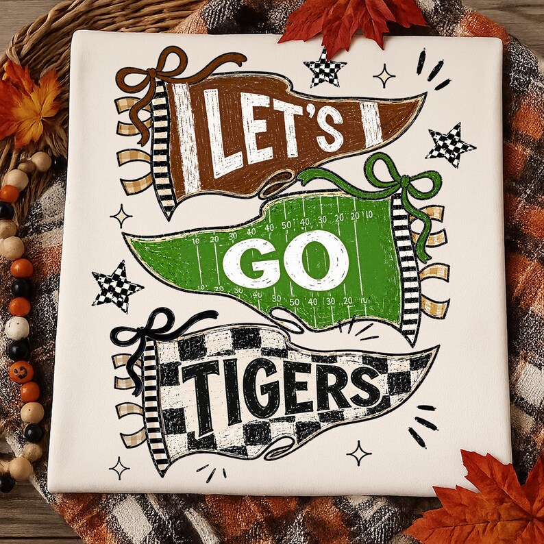 May include: A white square sign featuring three pennants with the text LET'S GO TIGERS. The top brown pennant says LET'S, the middle green football field pennant says GO, and the bottom checkered pennant says TIGERS, accented by small stars.