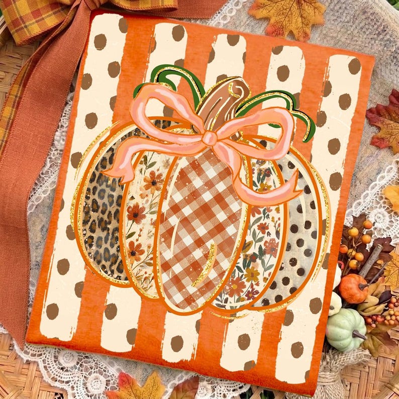 May include: A rectangular sign featuring a central pumpkin illustration with a light pink bow. The pumpkin has segments with leopard print, floral patterns, and orange gingham. The background has vertical orange and white polka dot stripes.