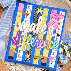 May include: A rectangular sign with a blue background featuring the text "make a difference" in white and colorful script. The design includes vertical stripes of yellow pencils, notebook paper, and black speckled patterns, with a school bus, ruler, stars, and a pink bow.
