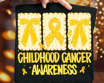 May include: Black tote bag with a yellow ribbon and bow design, and the words "CHILDHOOD CANCER AWARENESS" in yellow. The design includes yellow ribbons and bows, promoting cancer awareness.