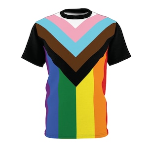 May include: A black t-shirt with a rainbow and brown, blue, and pink chevron design. The chevron design is centered on the shirt and the rainbow stripes are on the bottom half of the shirt.