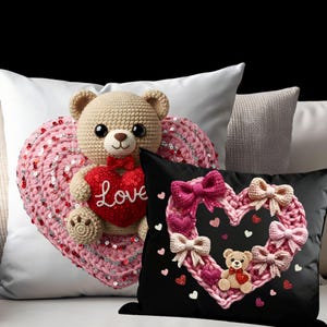 May include: A collection of decorative pillows featuring heart and teddy bear designs. One pillow has a pink heart with sequins and a crocheted teddy bear holding a red heart with the word "Love". Another pillow is black with a pink heart and bows.