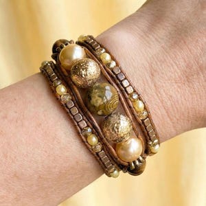 May include: A set of three ceramic mugs with a speckled, matte finish. The mugs are in shades of cream, light gray, and dark gray. Each mug has a simple, minimalist design, perfect for coffee or tea.