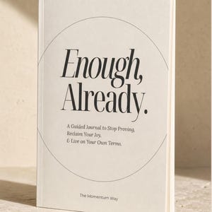 May include: A cream-colored guided journal with black text on the cover that reads Enough, Already. A Guided Journal to Stop Proving, Reclaim Your Joy, & Live on Your Own Terms. The Momentum Way is printed at the bottom inside a thin black circle.