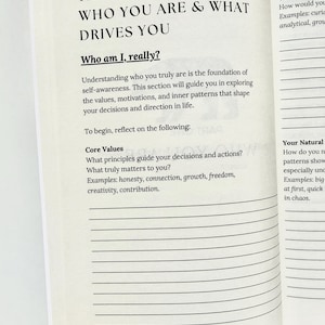 May include: Open book with text: "THE DEEP DIVE: WHO YOU ARE & WHAT DRIVES YOU." The page includes the question "Who am I, really?" and prompts for self-reflection on core values and motivations. The book is open to page 15.