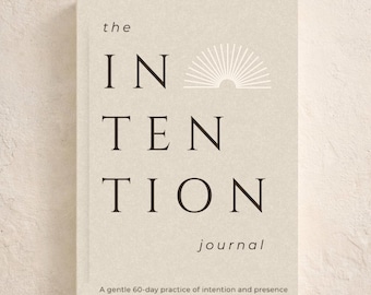 May include: A beige journal titled "The Intention Journal" with black lettering. The cover features the word "INTENTION" stacked vertically, with "journal" below. The top reads "A Guided Journal for Awareness" and the bottom reads "A gentle 60-day practice of intention and presence."