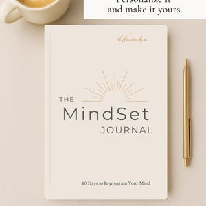 May include: A cream-coloured journal titled "The MindSet Journal" with gold accents and a gold pen. The journal has the text "40 Days to Reprogram Your Mind." A cup of coffee sits to the left. The text "Personalize it and make it yours" is at the top.