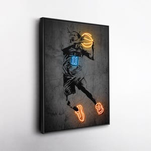 May include: A framed wall art print featuring a black and white sketch of a basketball player in motion. The player wears a jersey with the number 11 in blue neon, holds a glowing orange neon basketball, and wears glowing orange neon sneakers.