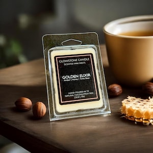 May include: A small, clear plastic container holds a wax melt with a white label that reads "GLOWSTONE CANDLE SCENTED WAX MELTS GOLDEN ELIXIR Amber | Honey | Tonka Bean HAND-POURED IN TX NATURAL COCONUTSOY WAX 2.5OZ | 70G".