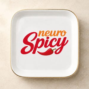 May include: A square white ceramic trinket dish with rounded corners and a gold-toned rim. The center features the text "neuro" in orange and "Spicy" in red, accompanied by a graphic illustration of a single red chili pepper.