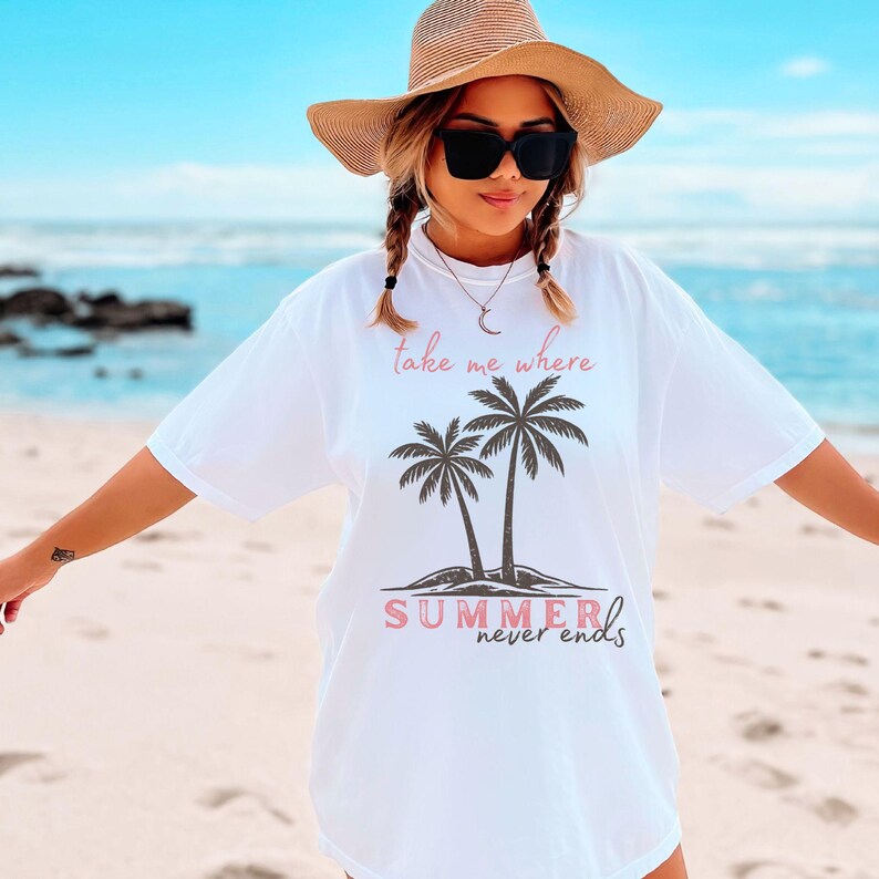 Retro beach graphic t-shirt featuring two vintage-style palm trees with the phrase “take me where summer never ends”