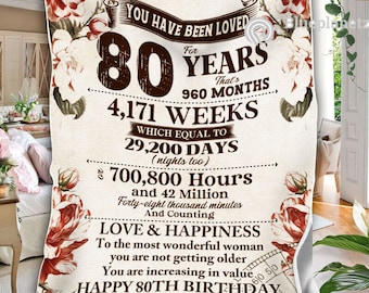 Puede incluir: Una manta de color beige y marrón con estampado floral y el texto "You have been loved for 80 years. That's 960 months, 4,171 weeks, which equal to 29,200 days (nights too), 700,800 hours and 42 million forty-eight thousand minutes. And counting. Love & Happiness. To the most wonderful woman you are not getting older. You are increasing in value. Happy 80th Birthday."