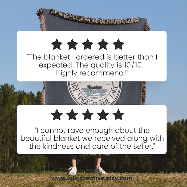 May include: A blue blanket with a fringed edge is held up against a blue sky. The blanket has a circular design with a boat and the text "ARE MADE AT THE LAKE". Customer reviews are displayed above and below the blanket.