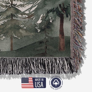 Detailed view of woven cotton threads on personalized couples blanket, forest trees and mountain design