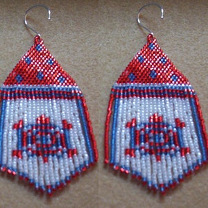 May include: A pair of red, white, and blue beaded earrings with a geometric design. The earrings are made with seed beads and have a fringe.
