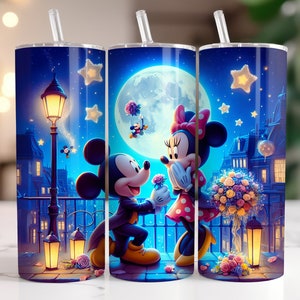 May include: A set of three blue and white insulated tumblers with a romantic scene of Mickey and Minnie Mouse under a starry night sky. The tumblers feature a moon, stars, and a street lamp.