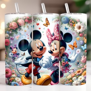 May include: Three stainless steel tumblers featuring a floral design and images of Mickey Mouse and Minnie Mouse. The tumblers are white with a clear lid and a straw.