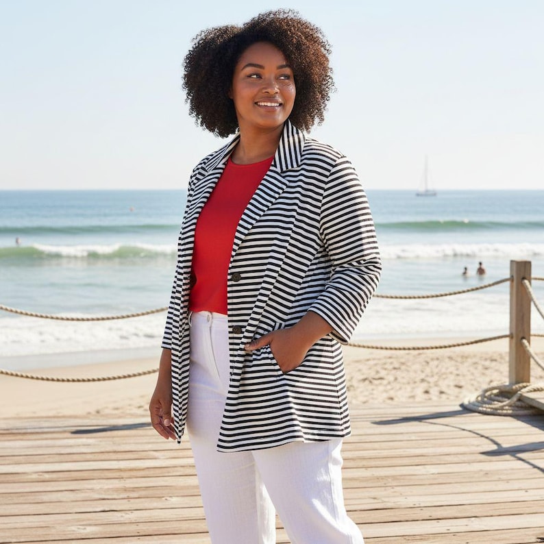 May include: A black and white striped blazer, red top, and white trousers. The blazer features a classic design with a two-button closure and pockets. The outfit is worn on a wooden boardwalk near the beach.