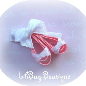 May include: A white bow with pink ribbon ballerina shoe hair clip. The clip is on a pink background with the text "oh so sweet" repeated.