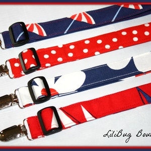 May include: Four fabric straps with silver clips and black buckles. The straps feature different red, white, and blue patterns, including polka dots, sailboats, and flowers.