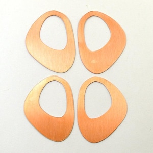 May include: Four copper-colored, abstract teardrop-shaped earring components. Each component has a rounded, open center and a smooth, polished surface. The earrings are arranged in a square formation against a white background, ideal for jewelry making.