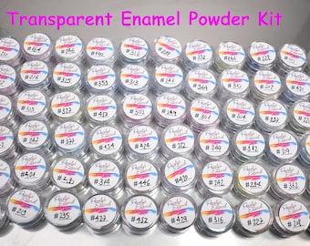 May include: A set of 48 small jars of transparent enamel powder. Each jar has a white label with a number on it. The jars are arranged in a grid pattern on a silver surface.