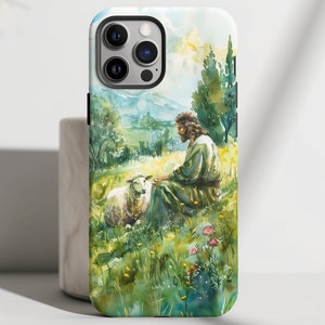 May include: A watercolor phone case featuring a man sitting in a field with a lamb. The man is wearing a long robe and the lamb is white. The background is a green field with trees and a blue sky.