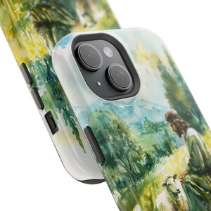 May include: A watercolor phone case featuring a painting of Jesus with a lamb in a green field. The case is white with a black camera cutout.