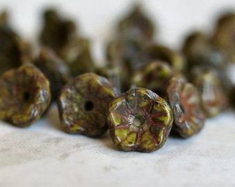 May include: A collection of green, brown, and yellow glass beads with a starburst pattern. The beads have a rustic, vintage look.
