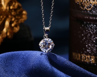 May include: A silver chain necklace with a large, round, clear cubic zirconia pendant.