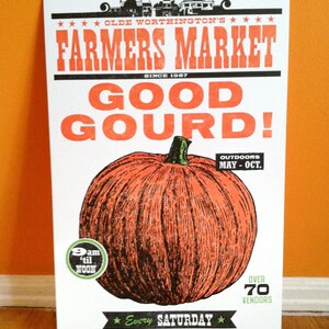 May include: A vintage-style poster advertising the Olde Worthington's Farmers Market. The poster features a large, orange pumpkin with a green stem and the text "Good Gourd!" in red and black lettering. The poster also includes the text "Every Saturday" and "Over 70 Vendors".