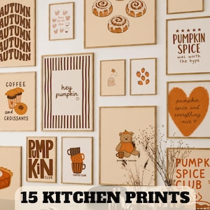 May include: A collection of fifteen wall art prints featuring autumn-themed illustrations including cinnamon rolls, coffee, pumpkins, and bears in warm brown and orange tones with text such as "hey pumpkin," "pumpkin spice," and "coffee club."