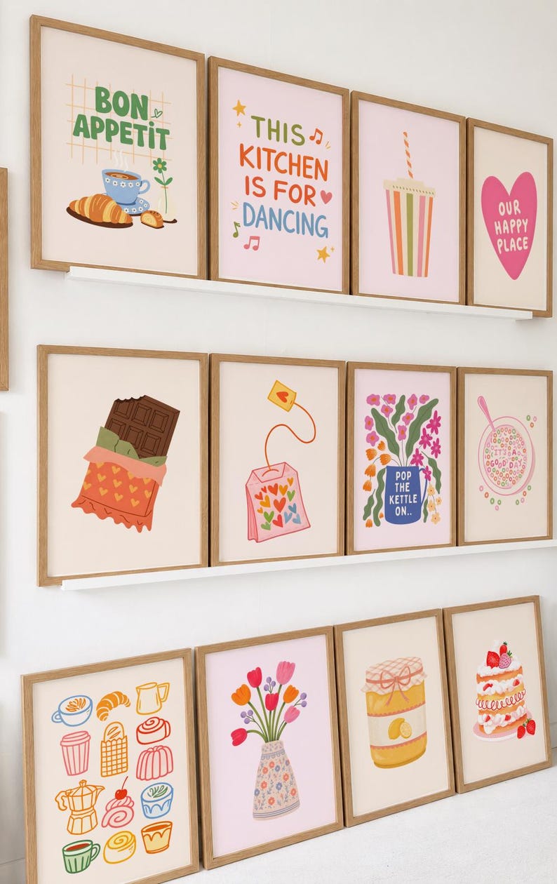 May include: A collection of framed art prints with a kitchen theme. The prints feature illustrations of food, drinks, and phrases like "Bon Appetit" and "This Kitchen is for Dancing." The color palette includes pastels and warm tones.
