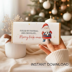 May include: A white chocolate bar wrapper with the text "Fueled by Football and Chocolate... Merry Kick-mas" and a Santa Claus illustration holding a soccer ball. Gold stars and the words "Instant Download" are also visible.